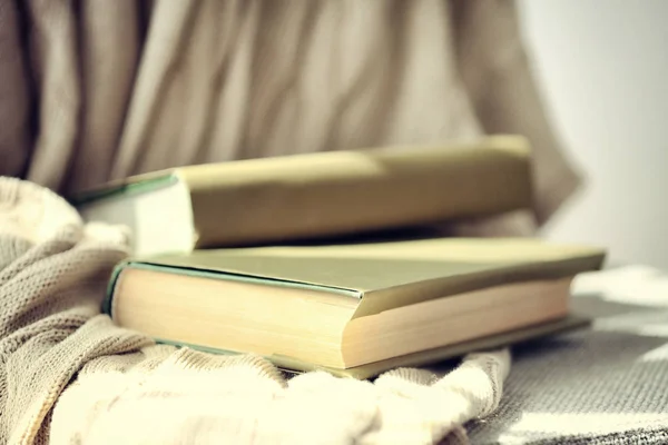 Books with plaid on chair — Stock Photo, Image