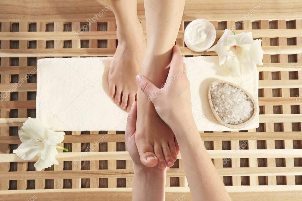 Foot massage in spa salon, closeup