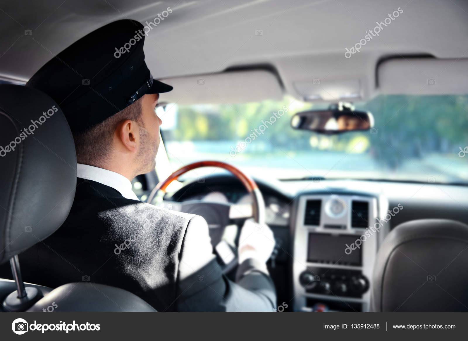 Chauffeur driving a car Stock Photo by ©belchonock 135912488