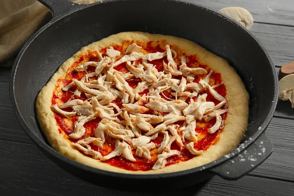 Unbaked pizza in pan