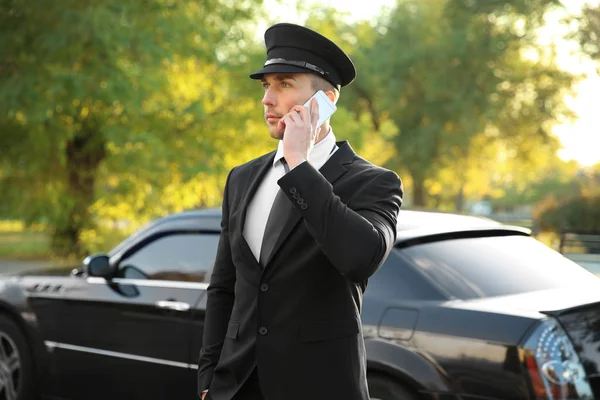 Chauffeur speaking by cell phone — стоковое фото