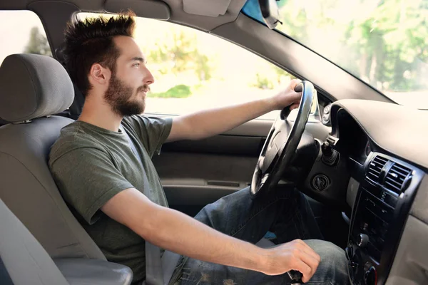 Young man driving car — Stock Photo, Image