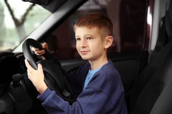 Хлопчик робить вигляд, що водить машину — стокове фото