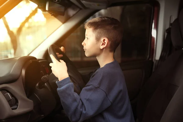 Boy pretending to drive car — Stock Photo, Image