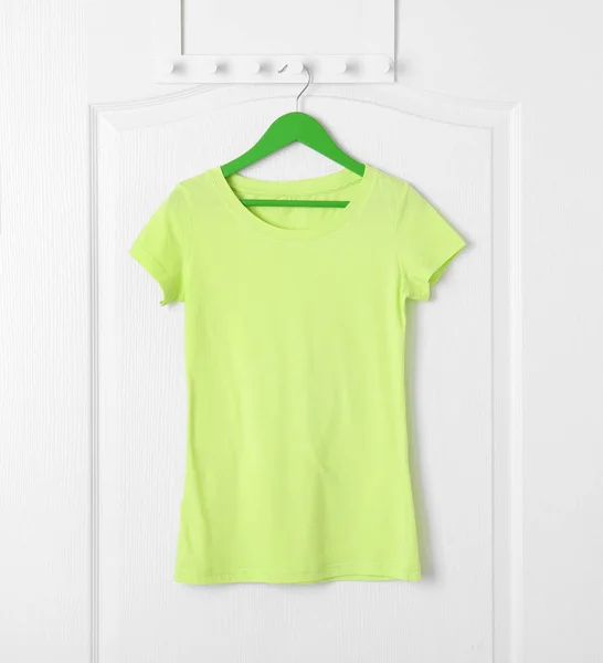 Blank t-shirt hanging on door — Stock Photo, Image