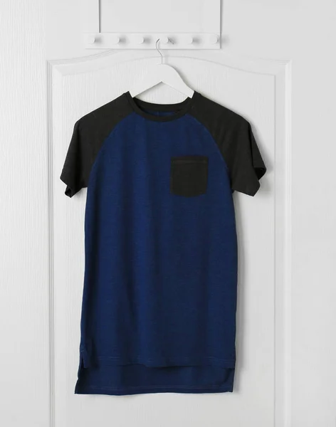 Blank t-shirt hanging on door — Stock Photo, Image