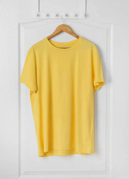Blank t-shirt hanging on door