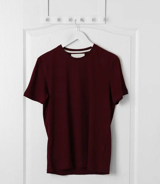 Blank t-shirt hanging on door — Stock Photo, Image