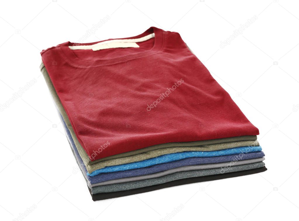 Stack of colorful t-shirts on white background