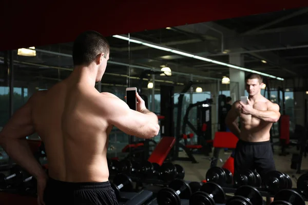 Young handsome man taking selfie in gym — Stock Photo, Image
