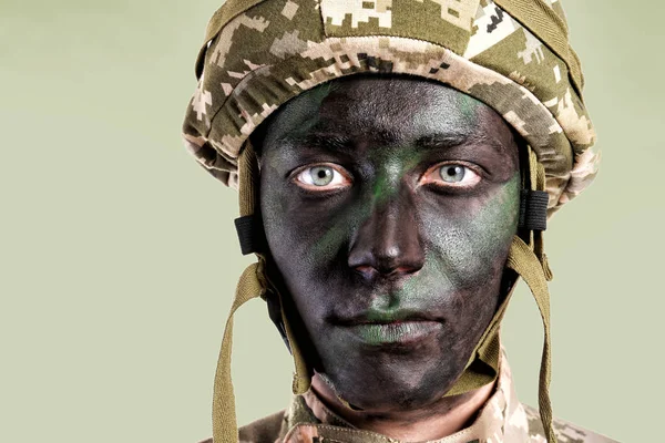 Portrait of soldier with painted face on white background — Stock Photo, Image