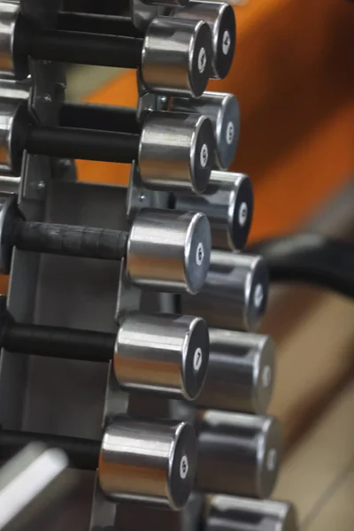 Rack with dumbbells in gym, close up view — Stock Photo, Image