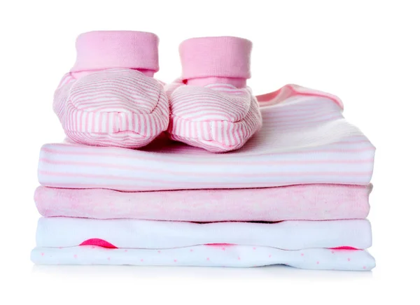 Baby shoes and pile of clothes — Stock Photo, Image