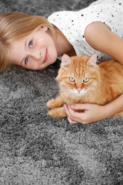 Beautiful little girl with red cat — Stock Photo, Image