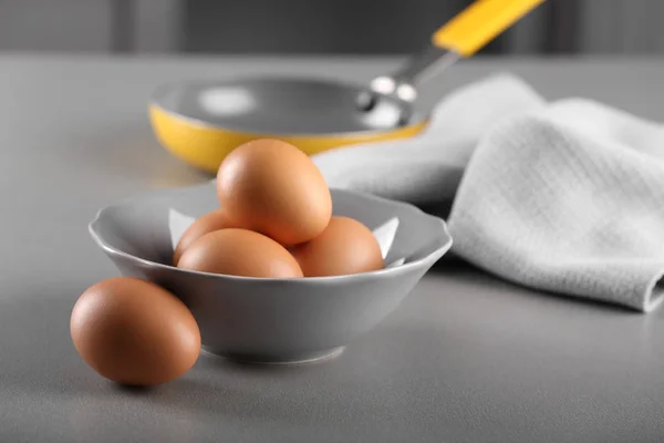 Raw eggs in bowl — Stock Photo, Image