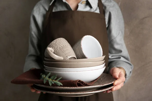 Hands holding pile of dish ware — Stock Photo, Image