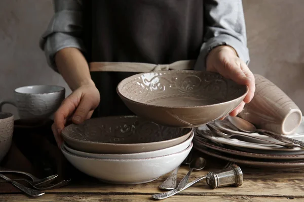 Female hands holding ceramic dishware — Stock Photo, Image