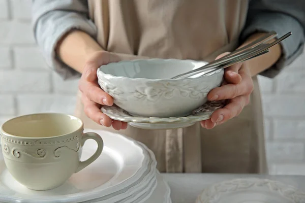 Female hands holding porcelain dishware — Stock Photo, Image