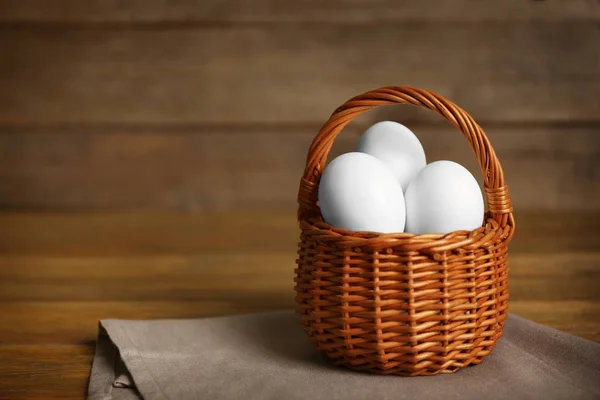 Raw eggs in basket — Stock Photo, Image