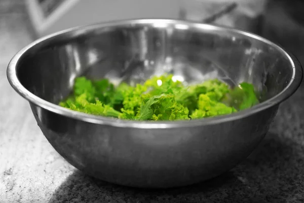 Metal bowl with green lettuce