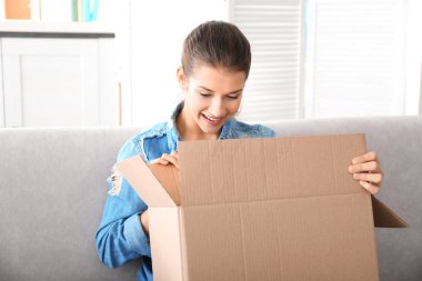 young woman opening box