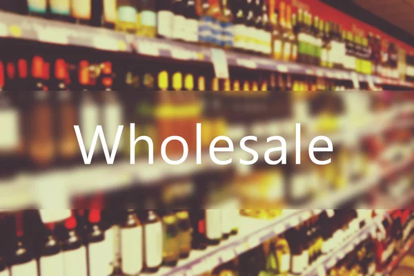 Word WHOLESALE on blurred alcohol — Stock Photo, Image