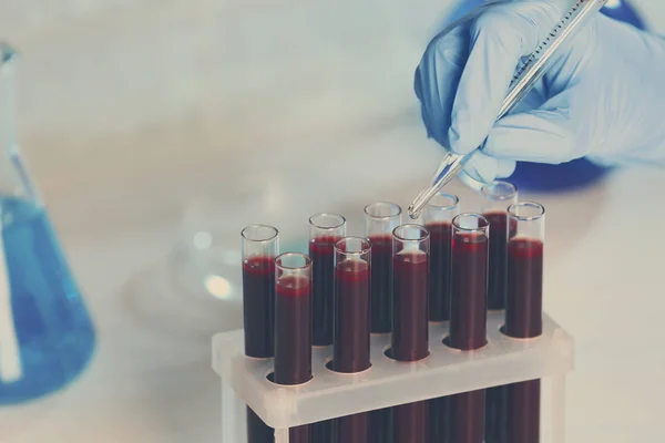 Hand working with test tubes — Stock Photo, Image