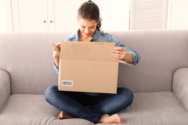 young woman opening box