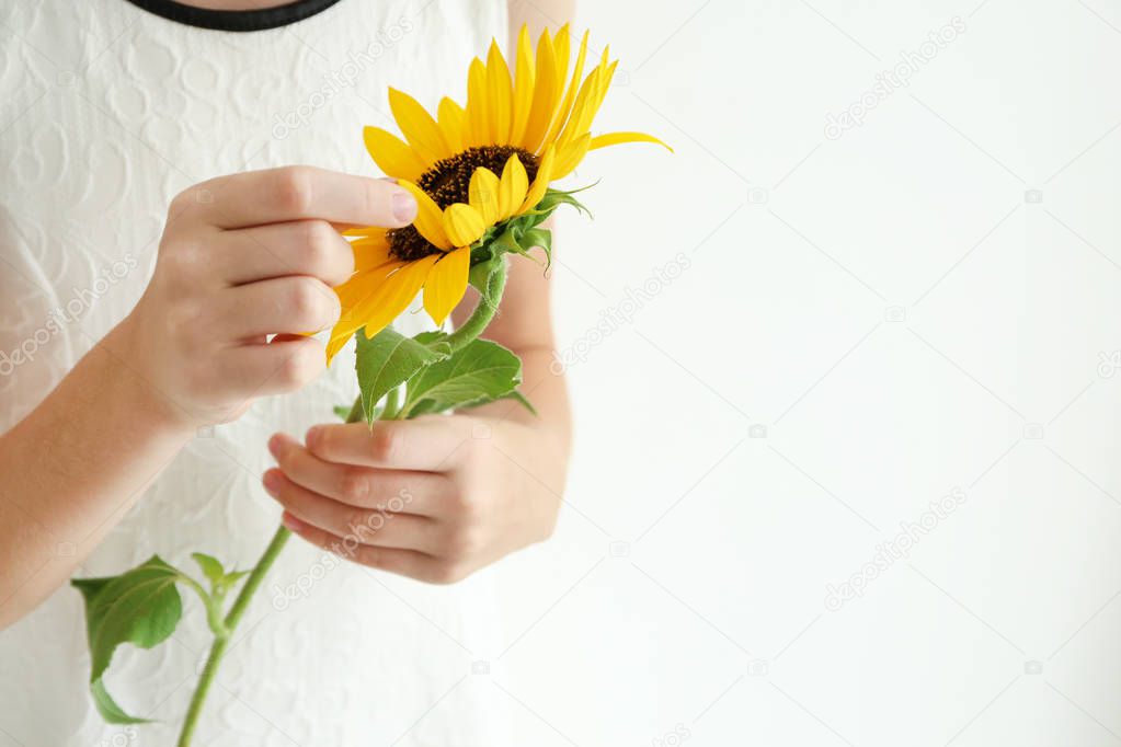 Girl holding sunflower  