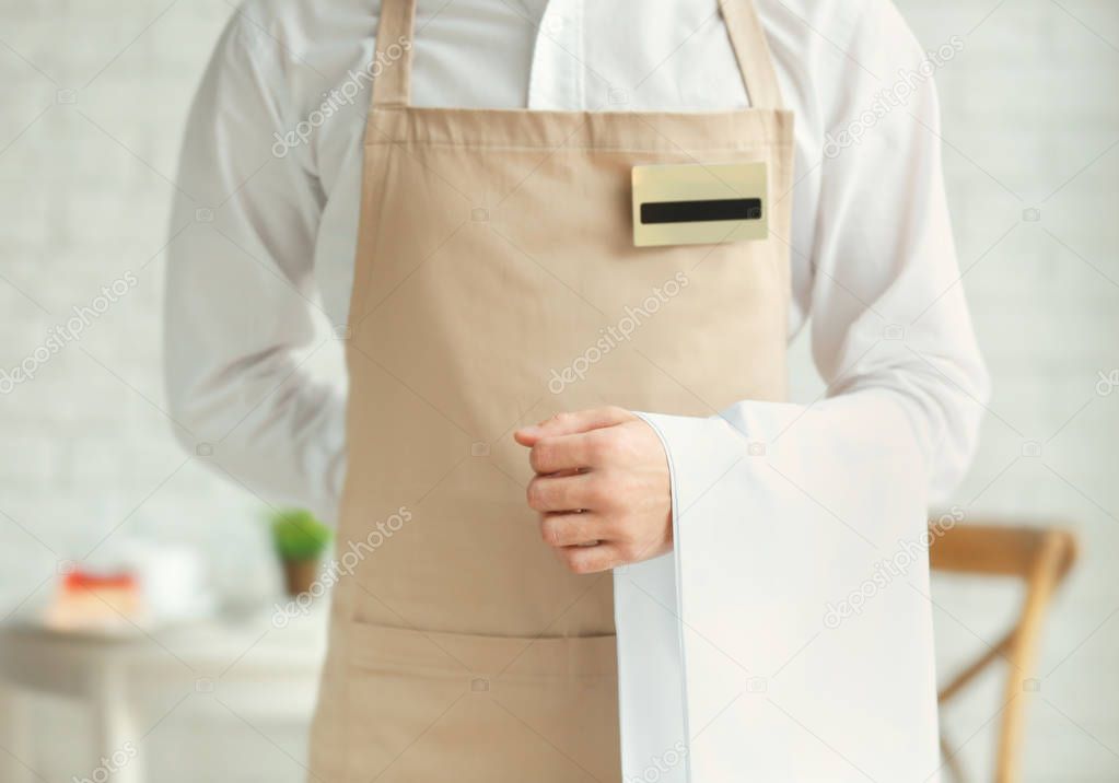 Waiter in beige apron