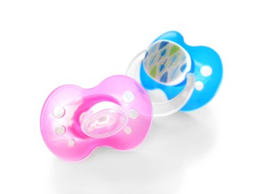 Baby pacifiers on white  clipart