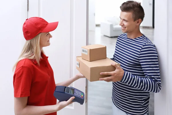 Young man receiving package from courier