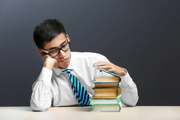 Student with books sitting at table — Stock Photo, Image