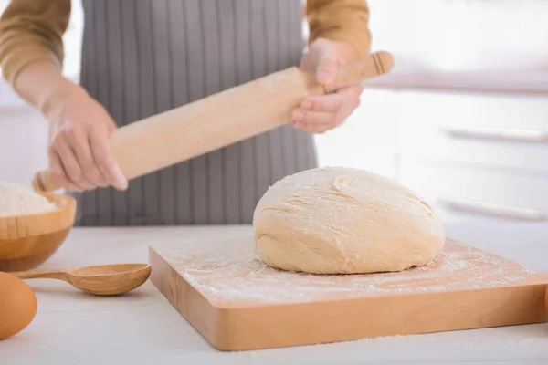 Woman preparing to roll out dough