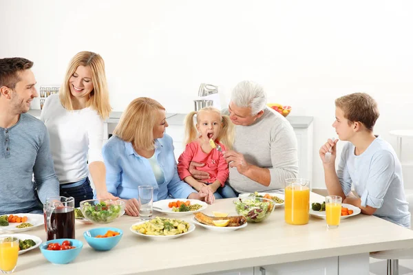 Happy family having lunch in kitchen