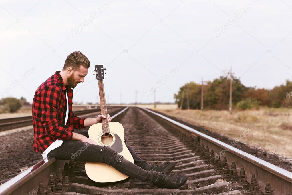Handsome man playing guitar 