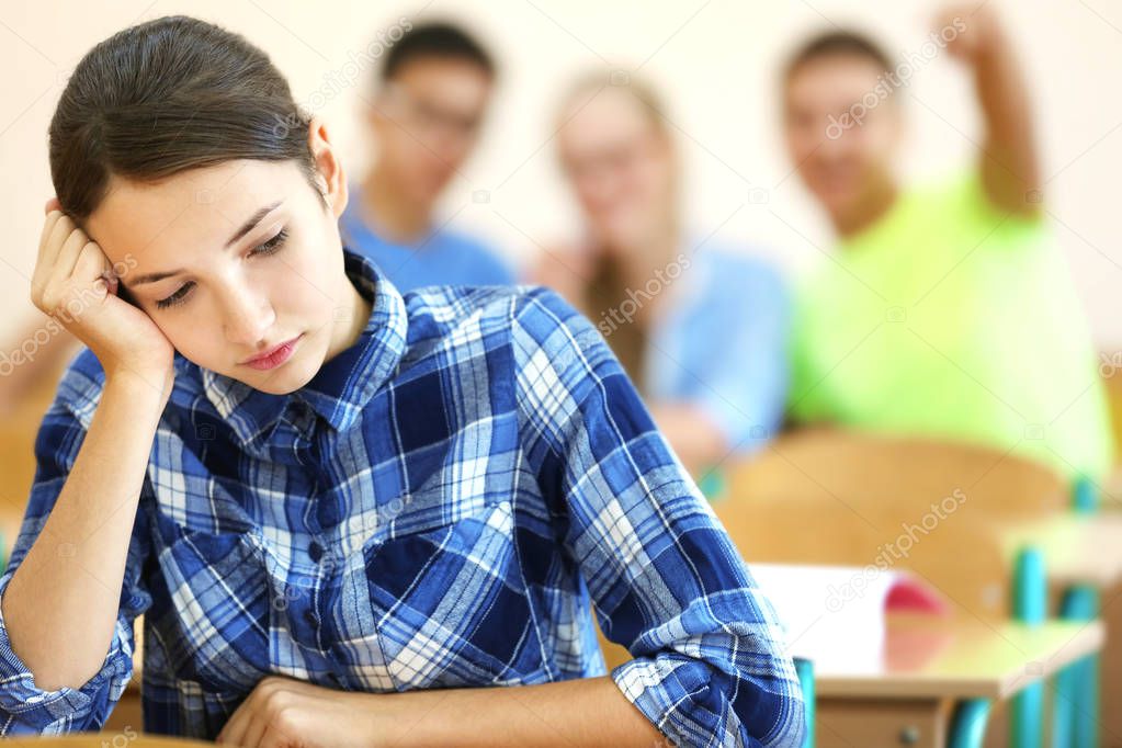 Student with group of classmates in classroom