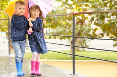 Çocuk renkli şemsiyesi altında