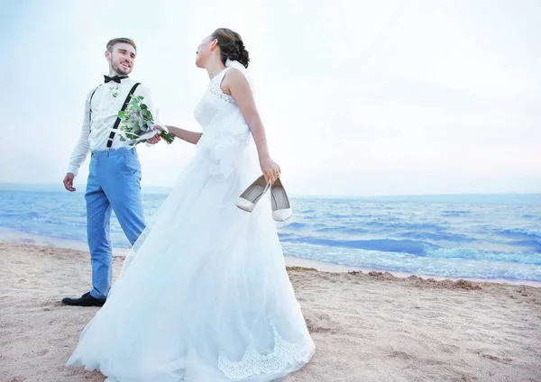 Groom and bride on river bank — Stock Photo, Image