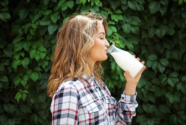 Woman with bottle of milk — Stock Photo, Image