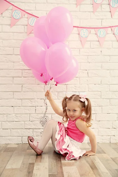 Girl holding party balloons — Stock Photo, Image