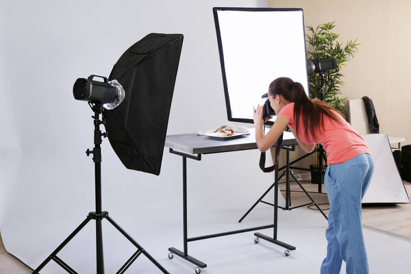 woman taking pictures of food