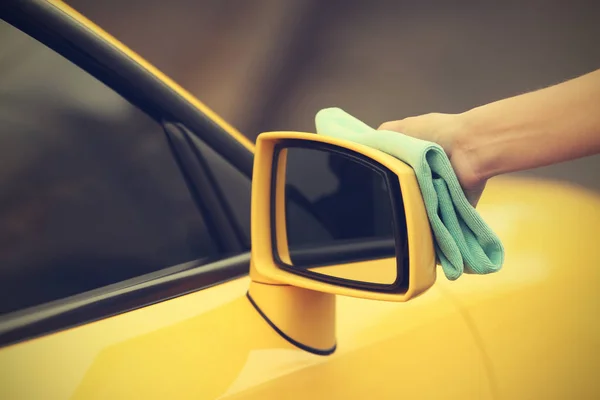 Mujer limpieza de manos coche amarillo — Foto de Stock