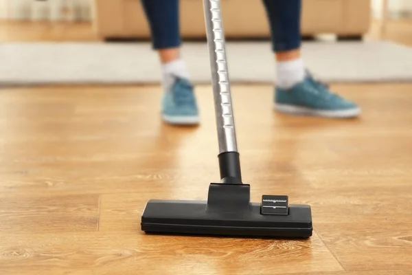 Cleaner hoovering floor — Stock Photo, Image