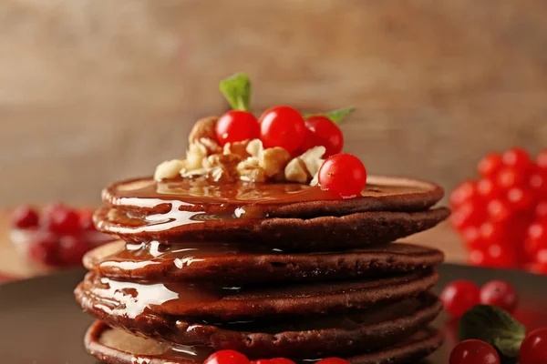 Chocolate pancakes with  viburnum and nuts — Stock Photo, Image