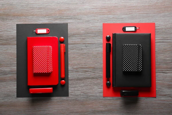Rote und schwarze Papeterie auf Holztisch — Stockfoto
