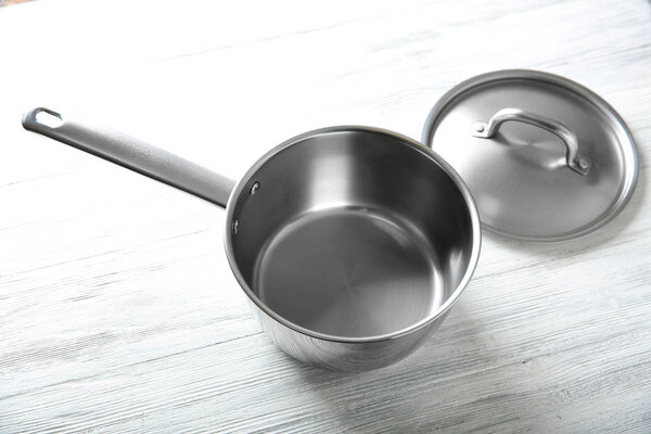 Stainless saucepan on table