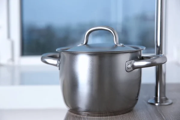 Stainless saucepan on table — Stock Photo, Image