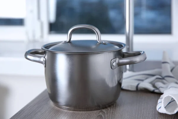 Stainless saucepan on table — Stock Photo, Image