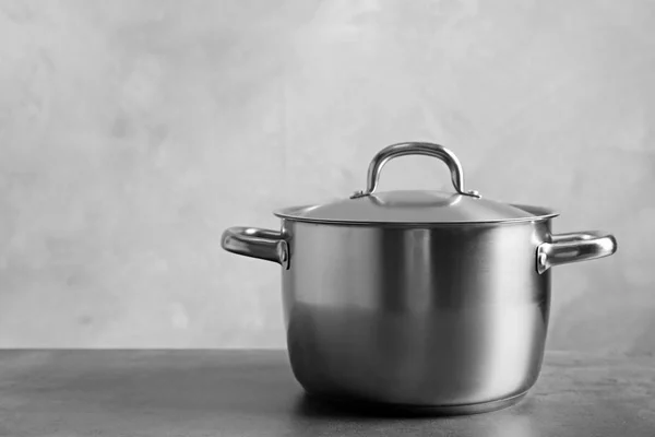 Stainless saucepan on table — Stock Photo, Image